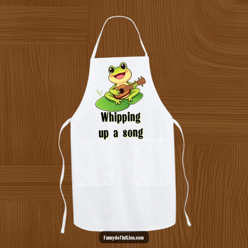 Funny cheerful frog playing a ukulele on an apron, ready for musical kitchen creations.