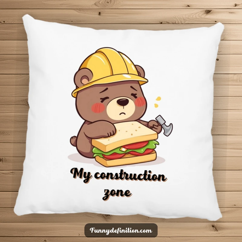 Funny pillow with a confused bear wearing a construction helmet, hilariously trying to build a sandwich using a hammer, bringing comfort and comedy.