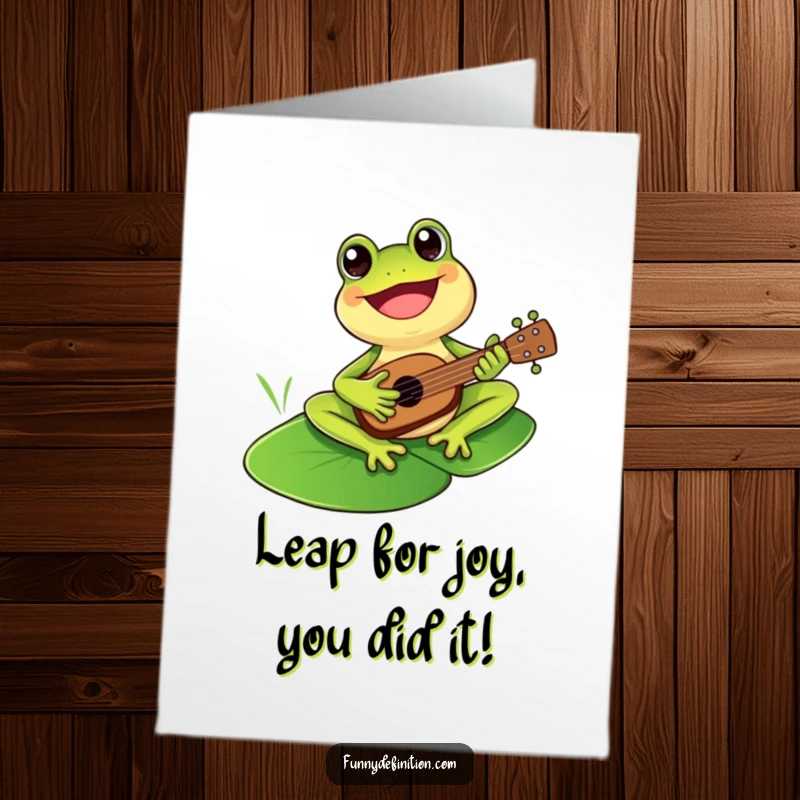 Funny Free Printable Congrats Card: A cheerful frog playing a ukulele on a lily pad, sending musical congratulations.