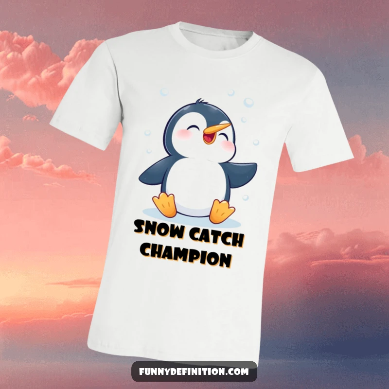 Funny t-shirt featuring an excited penguin actively trying to catch delicate falling snowflakes with its beak, embracing winter's magic.